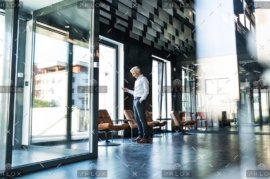 demo-attachment-30-Mature-businessman-with-smartphone-in-the-office.